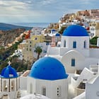 Blue domed church and houses in Oia